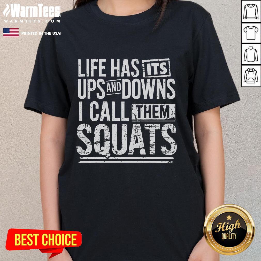 Ladies working out at Awesome Fitness Gym, squatting with weights in stylish workout tees for an effective fitness routine.