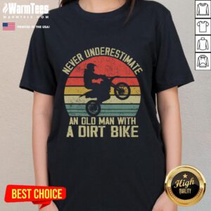 Vintage sunset graphic tee featuring an old man on a dirt bike with the phrase 'Never Underestimate an Old Man'.