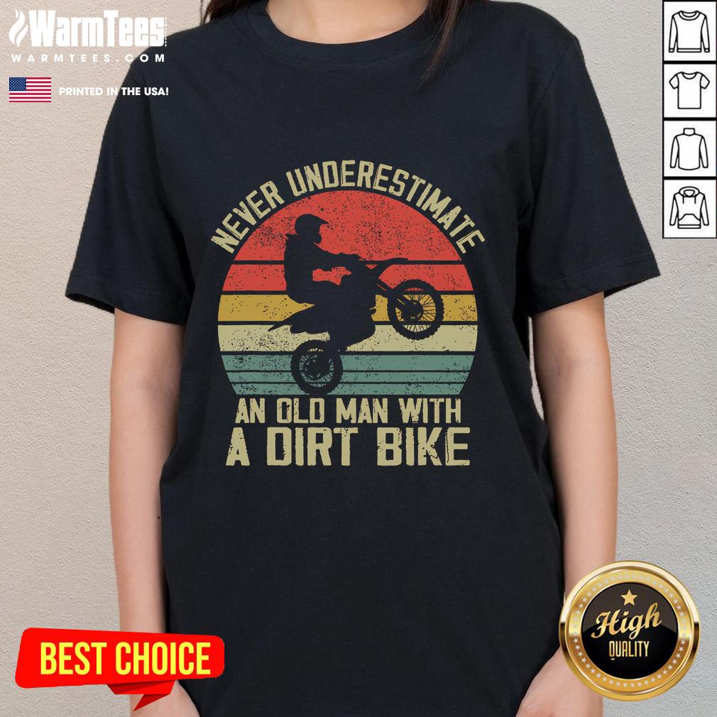 Vintage sunset graphic tee featuring an old man on a dirt bike with the phrase 'Never Underestimate an Old Man'.
