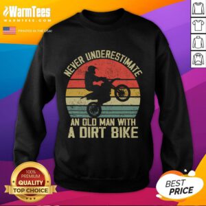 Vintage sunset sweatshirt featuring the phrase 'Never Underestimate an Old Man with a Dirt Bike' in bold design.