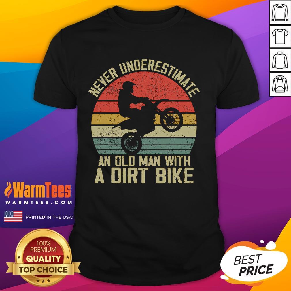 Alt Text: Vintage sunset T-shirt featuring the phrase Never Underestimate An Old Man With A Dirt Bike. Perfect for bike enthusiasts.
