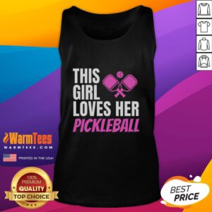 Girl in a pickleball tank top smiles on the court, showcasing her love for the sport and stylish athletic wear.