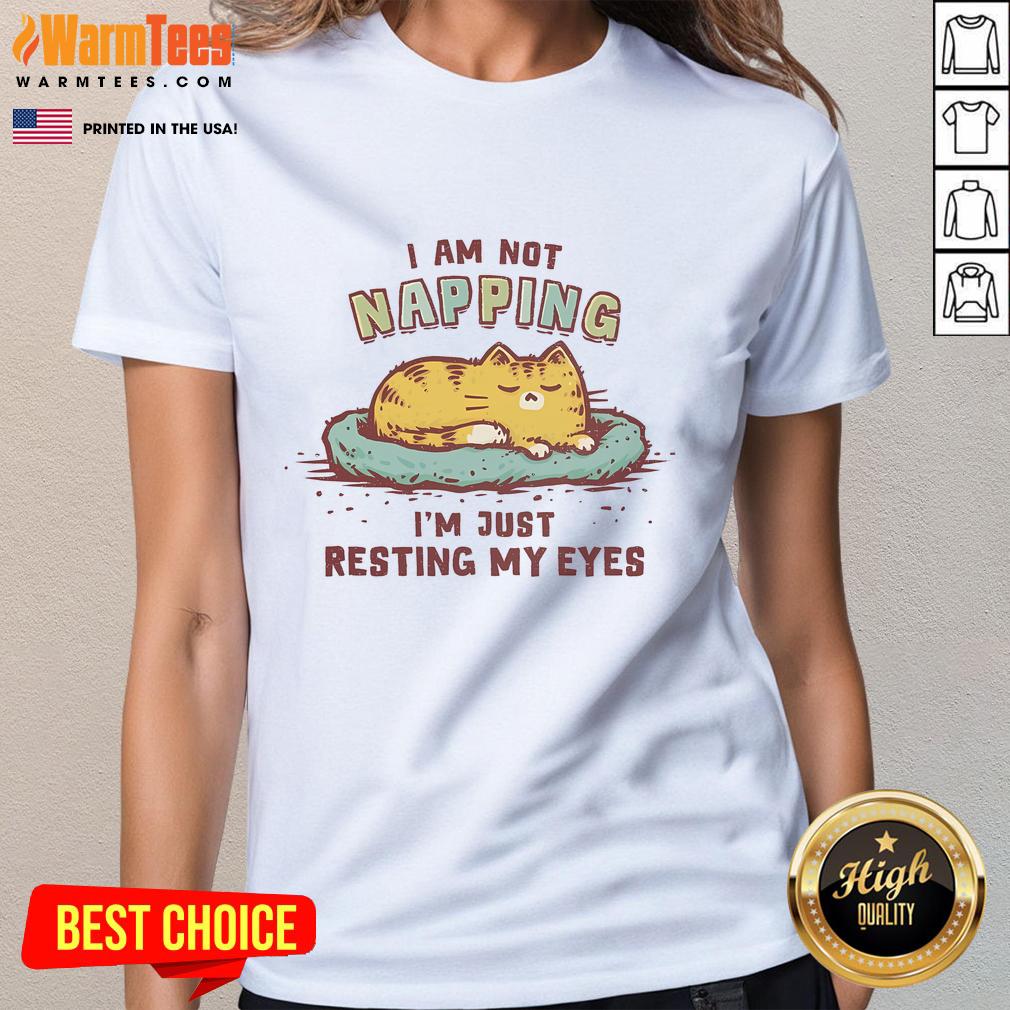 Alt Text: Cute cat lounging with eyes closed on 'I Am Not Napping, I'm Just Resting My Eyes' tee for cat lovers.