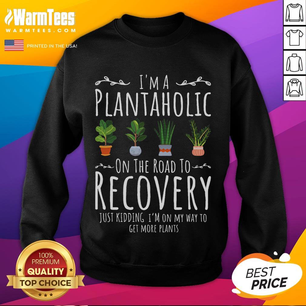Funny gardener wearing 'I'm a Plantaholic on the Road to Recovery' sweatshirt, showcasing love for gardening humor.