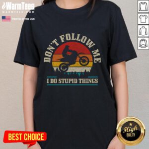 Vintage motocross tee for ladies featuring 'Don't Follow Me, I Do Stupid Things' design against a sunset backdrop.