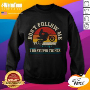 Vintage motocross sweatshirt featuring 'Don't Follow Me, Do Stupid Things' design against a sunset backdrop.