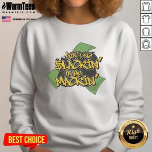 Person wearing a 'Good Ain't No Slackin In My Mackin' sweatshirt, showcasing stylish streetwear in a vibrant urban setting.