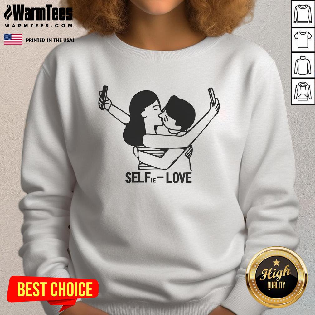 Person wearing a Good Selfie Love sweatshirt, radiating confidence and style in a cozy, casual setting.