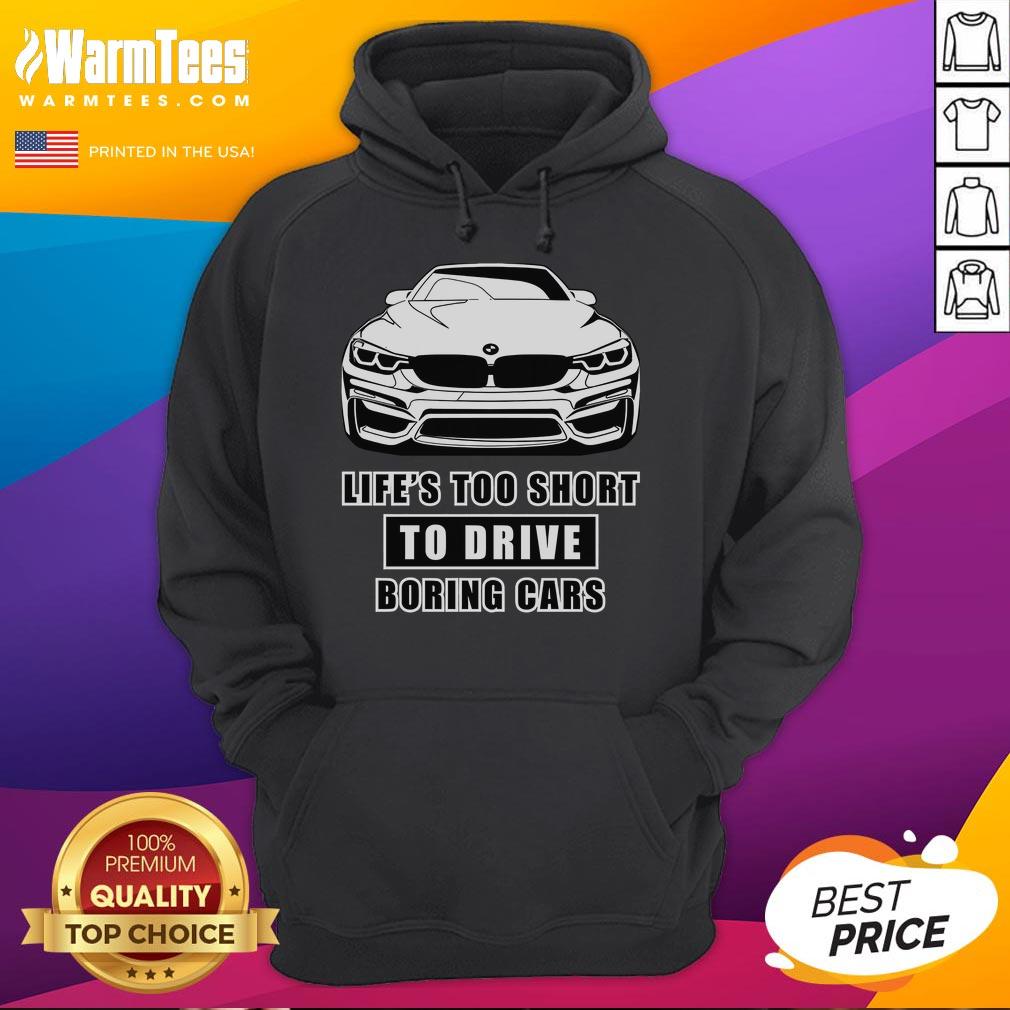Funny 'Life's Too Short to Drive Boring Cars' BMW hoodie showcased in a stylish urban setting, perfect for car enthusiasts.