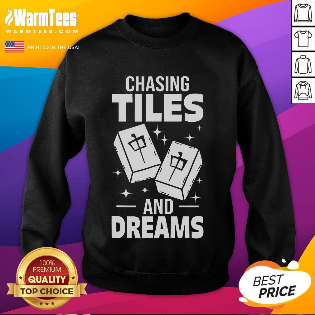 Alt Text: Asian player wearing a Good Mahjong sweatshirt, chasing tiles and dreams in a lively mahjong game setting.