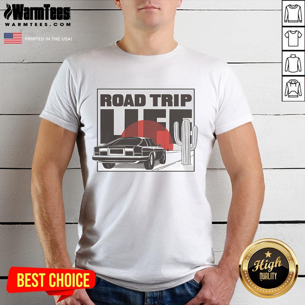 Vintage car at sunset on a road trip, featured on a 'Nice Road Trip Life' T-shirt design, perfect for adventure lovers.