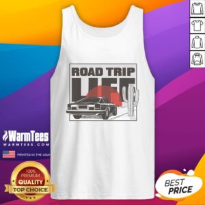 Vintage car on a scenic road trip at sunset, featuring a person in a tank top enjoying the beautiful view.