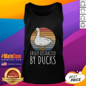 Adorable duck wearing a tank top, easily distracted by other ducks in a serene pond setting.