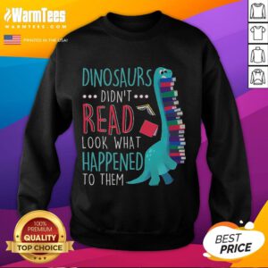 Cute teacher wearing 'Dinosaurs Didn't Read' sweatshirt, promoting book reading with playful dinosaur graphics.
