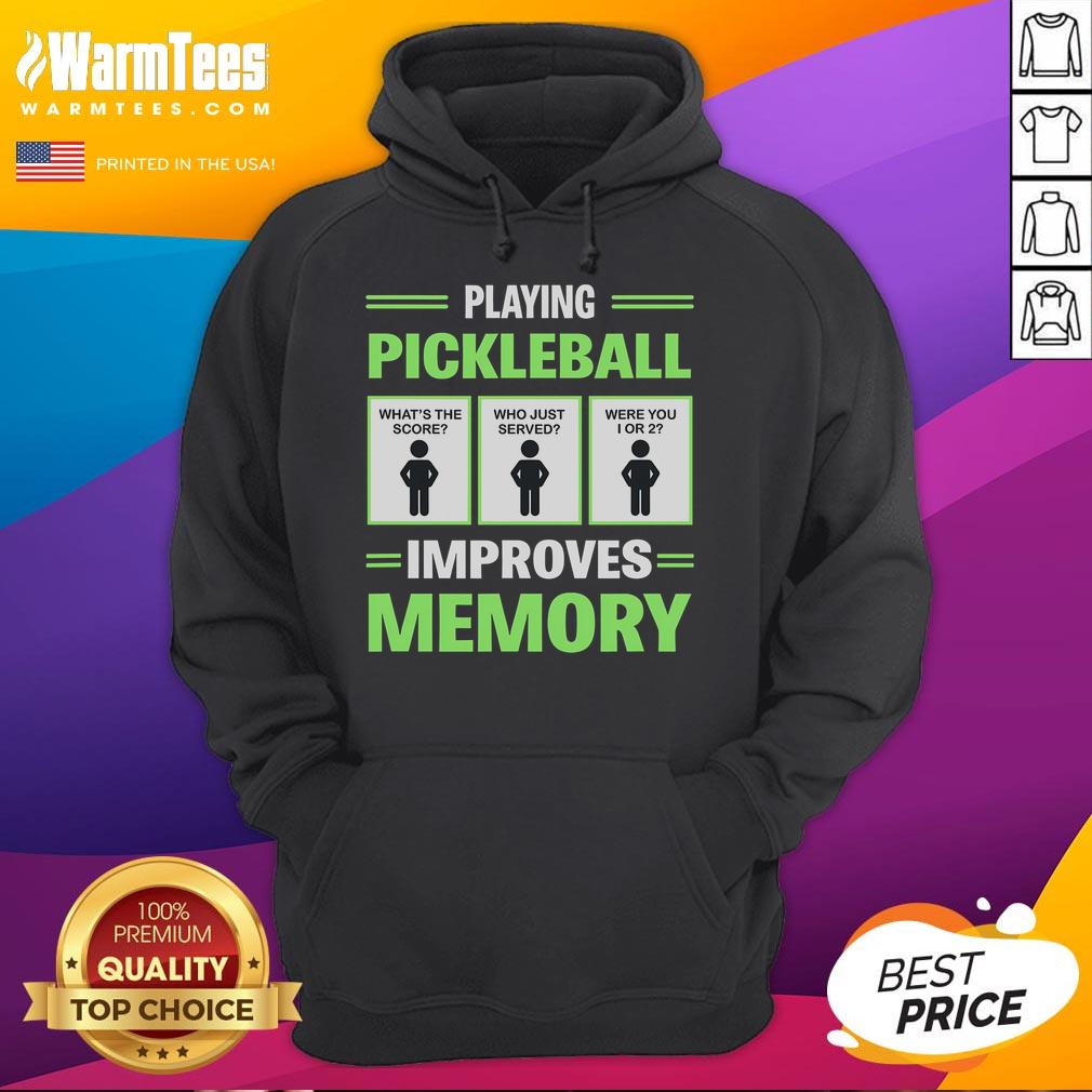 Person wearing a Funny Playing Pickleball Improves Memory hoodie, laughing while playing pickleball on a sunny court.