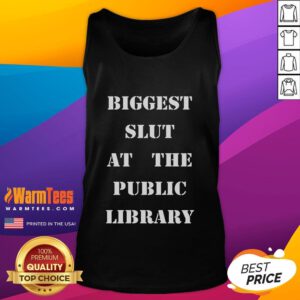 Woman wearing 'Good Biggest Slut At The Public Library' tank top, posing confidently in a library setting.