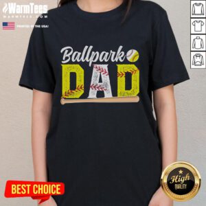Happy dad wearing a 'Baseball Softball Dad' tee at the ballpark, enjoying time with his kids during a game.
