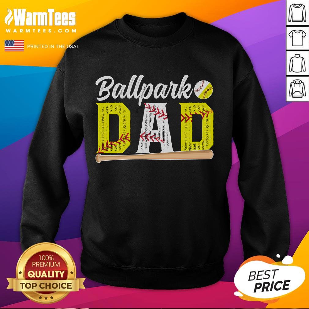 Happy dad wearing a 'Baseball Softball Dad of Ballers' sweatshirt at the ballpark, enjoying a game with family.