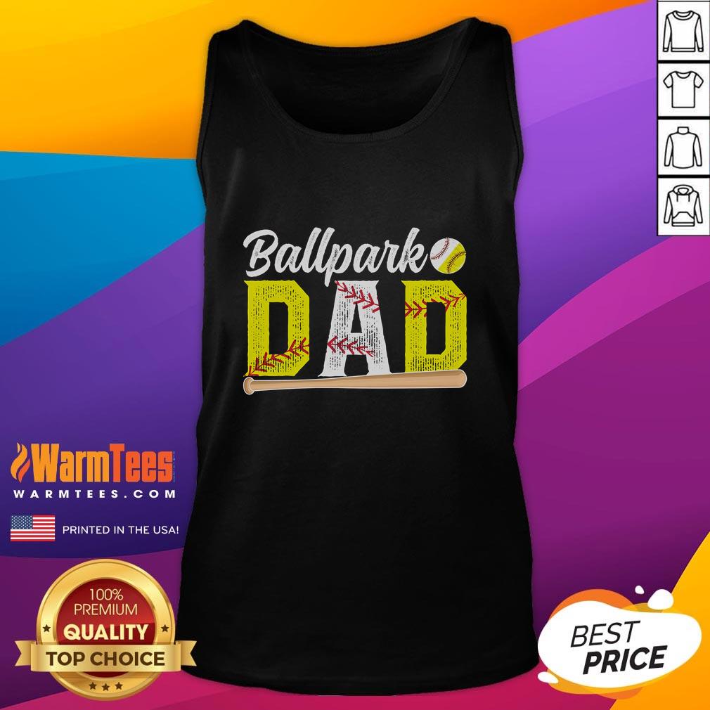 Happy dad wearing a tank top that says 'Dad of Ballers' at a baseball and softball game, celebrating with joy.