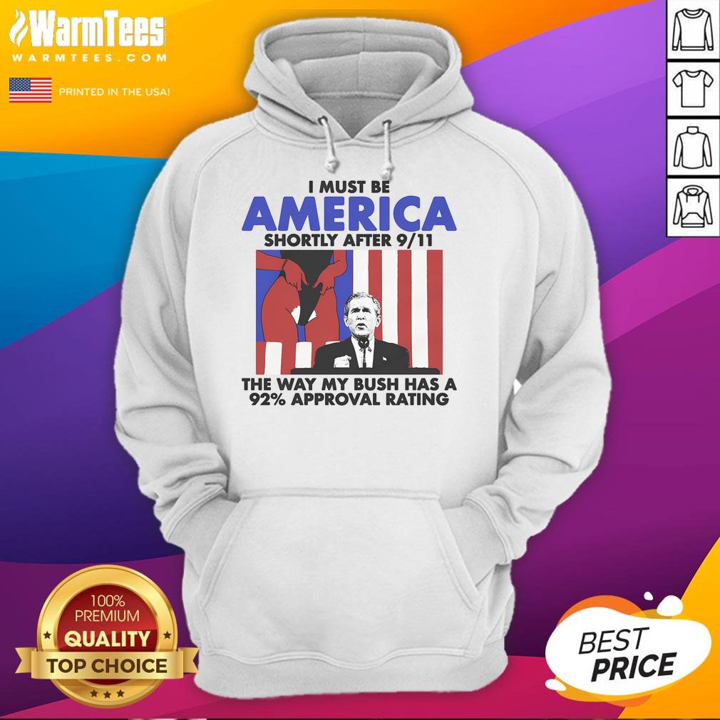 Man wearing 'Hot I Must Be America' hoodie with Bush 92% approval rating, reflecting post-9/11 patriotism.