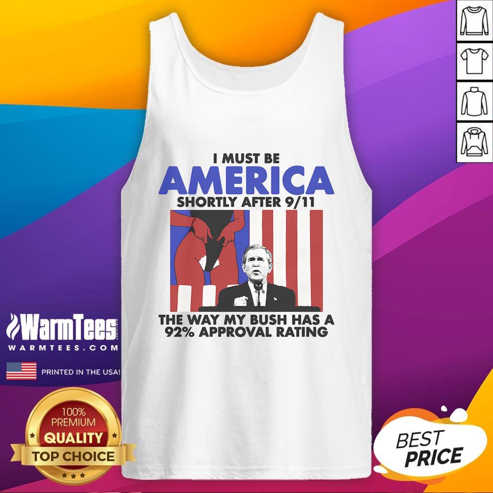 Man wearing 'Hot I Must Be America' tank top, referencing Bush's 92% approval post-9/11, showcasing patriotic humor.