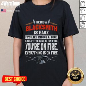 Alt Text: Funny blacksmith tee for ladies: 'Being a blacksmith is easy, like riding a bike, except everything is on fire.'