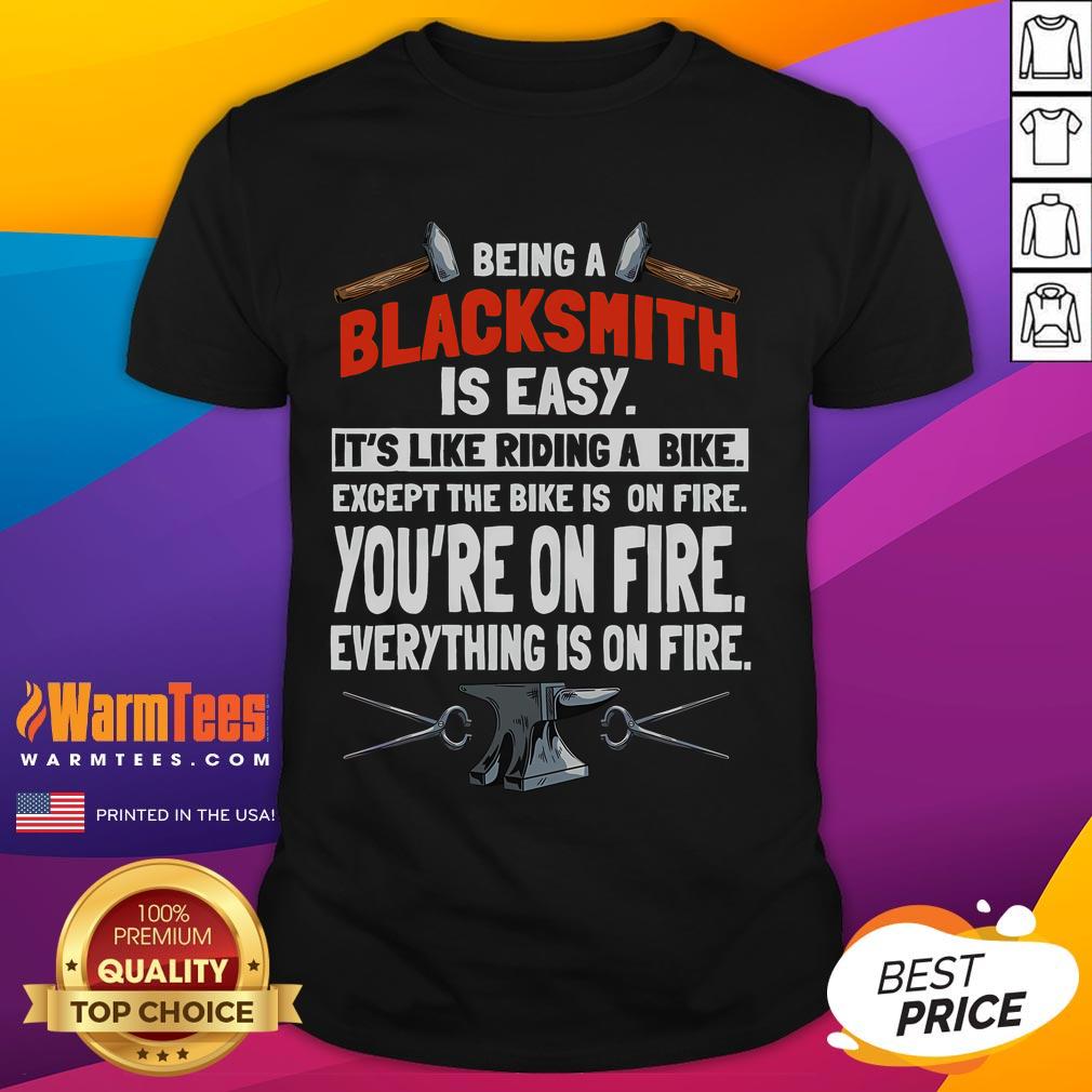 Funny blacksmith t-shirt design: 'Being a Blacksmith Is Easy, It's Like Riding a Bike, Except Everything Is On Fire'.
