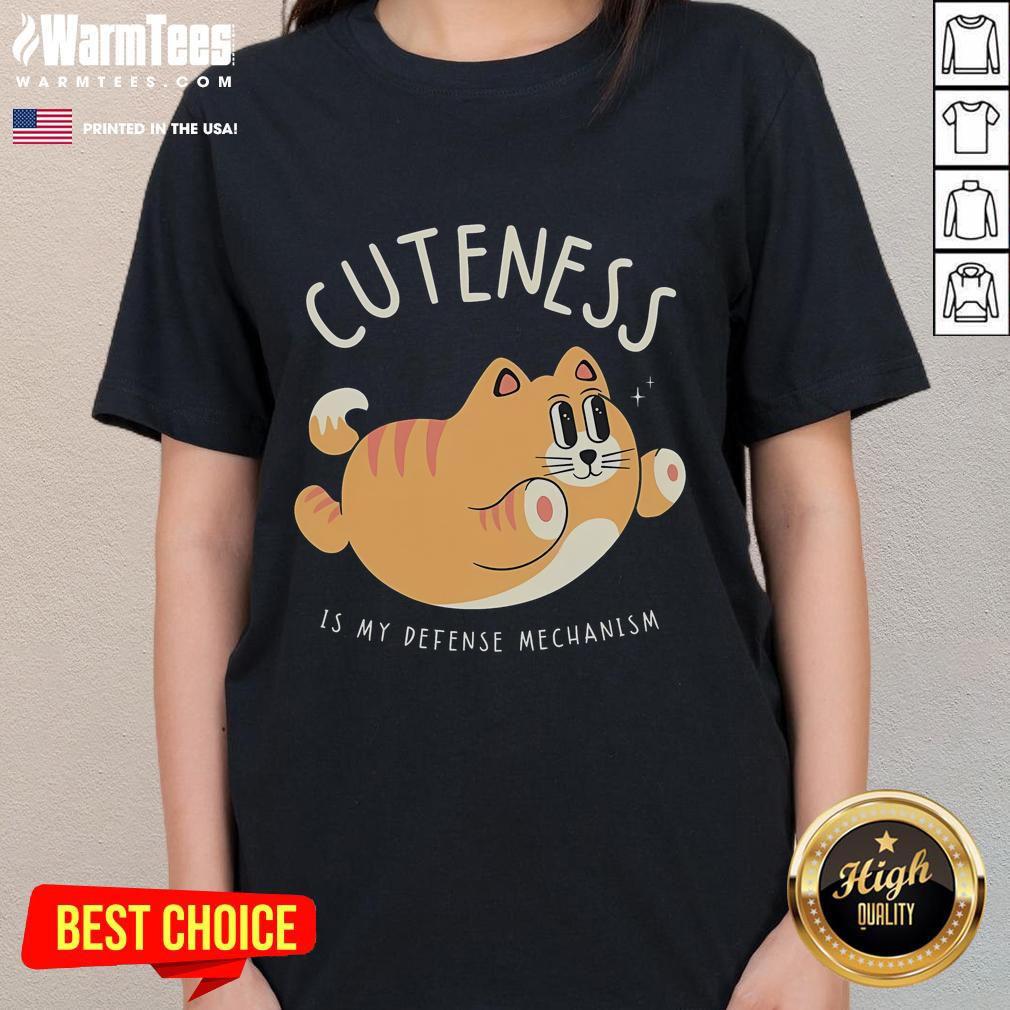 Funny cat graphic tee with the phrase 'Cuteness Is My Defense Mechanism' perfect for cat lovers and humor enthusiasts.