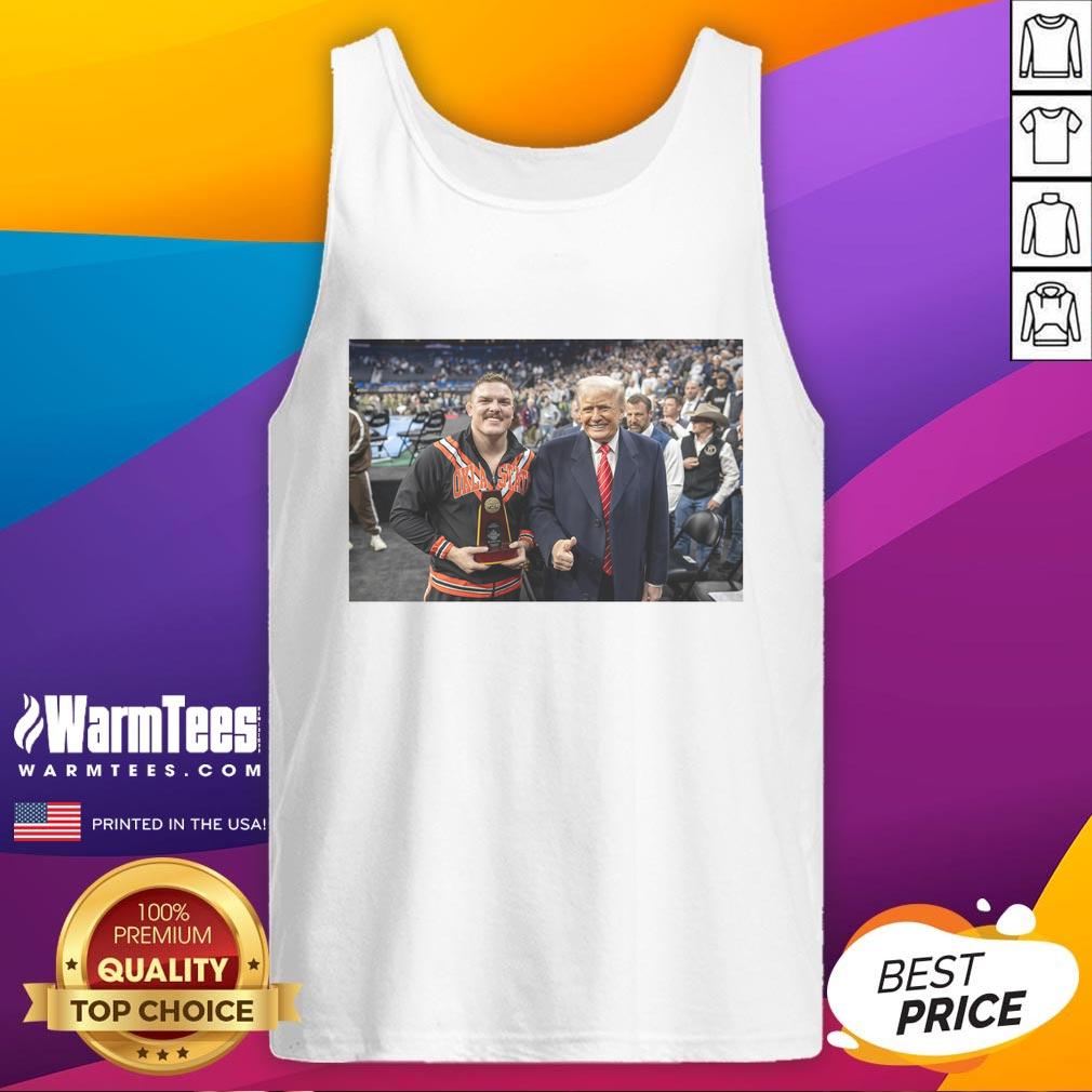 Alt Text: Wyatt Hendrickson wearing a tank top featuring Donald Trump, showcasing the hot best boss in the business theme.