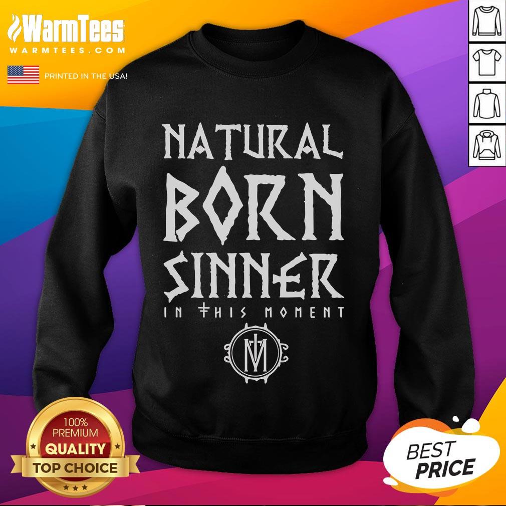 Alt Text: Model wearing Good In This Moment Natural Born Sinner sweatshirt in a cozy urban setting, showcasing stylish streetwear.