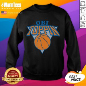 Obi Toppin wearing a New York Knicks sweatshirt during a game, showcasing team spirit and style.
