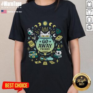 Cute witch cat at work on 'Go Away I'm Busy' ladies tee, perfect for cat lovers and Halloween enthusiasts.