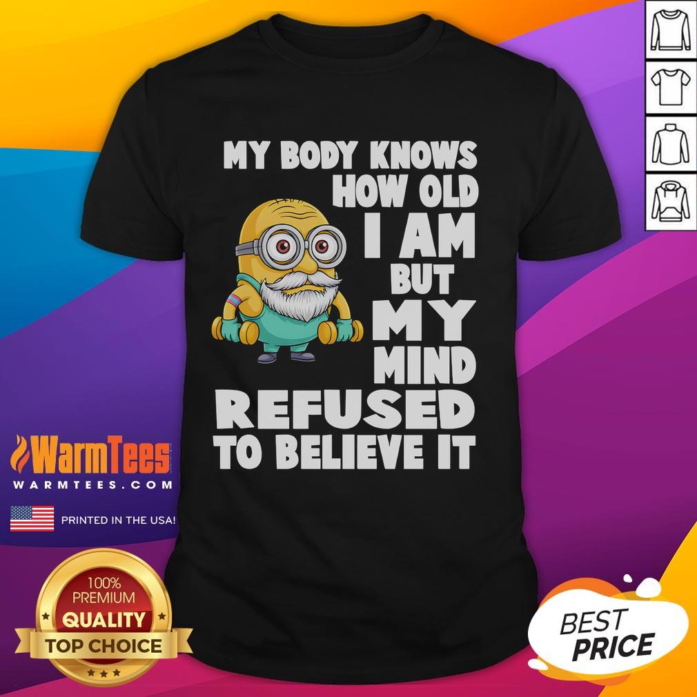 Funny Minion t-shirt with 'My Body Knows How Old I Am But My Mind Refuses To Believe It' quote in vibrant colors.