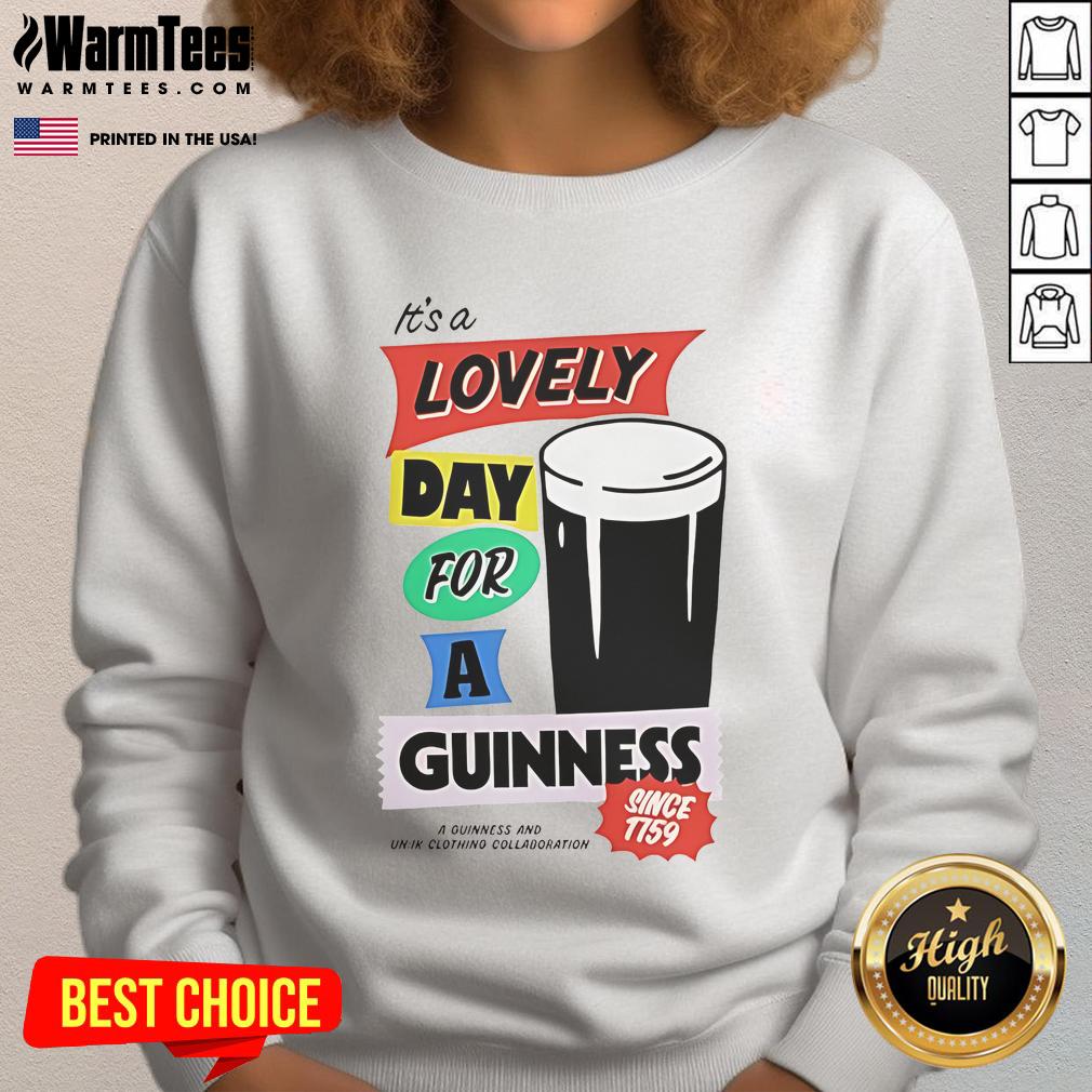 Cozy 'Good It's a Lovely Day for a Guinness' sweatshirt displayed on a wooden background, perfect for beer lovers.