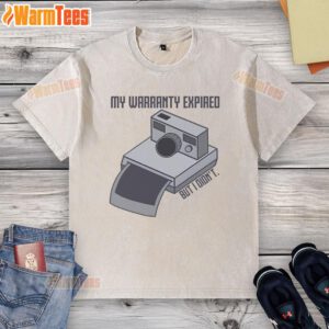Vintage instant camera graphic on a washed t-shirt with text 'My Warranty Expired But I Didn't' in stylish design.
