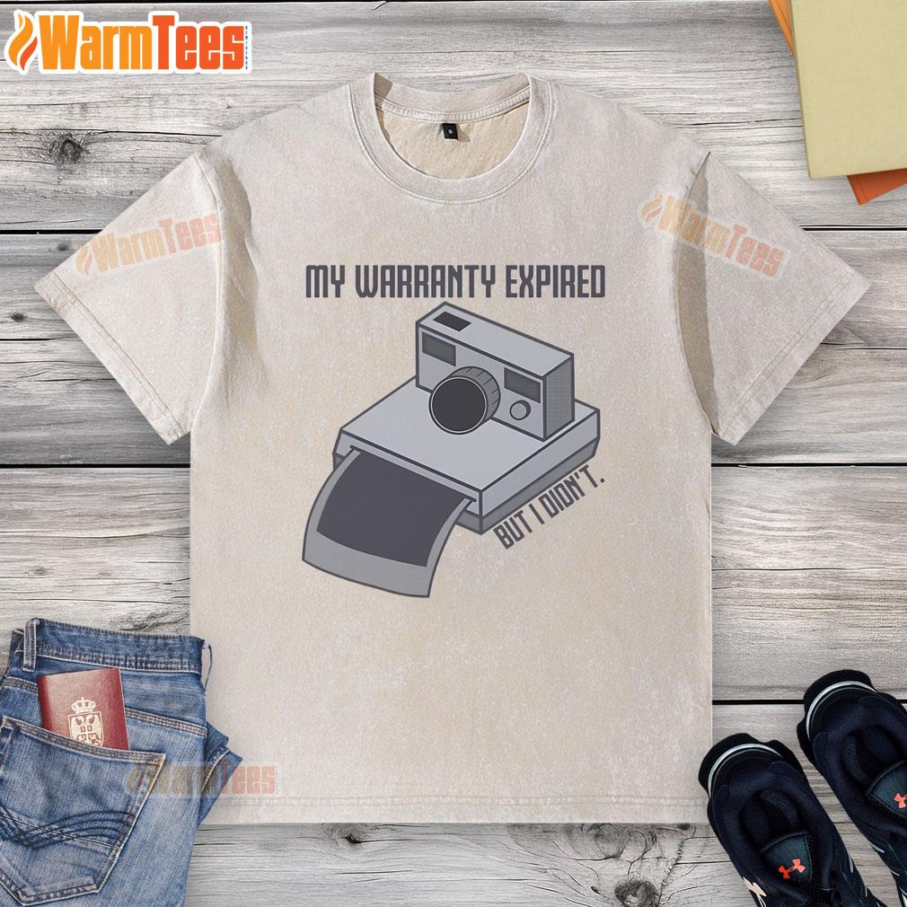 Vintage instant camera graphic on a washed t-shirt with text 'My Warranty Expired But I Didn't' in stylish design.