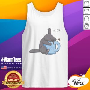 Cute cat playfully submerged in a coffee cup, wearing an I'm OK tank top, showcasing quirky pet humor.