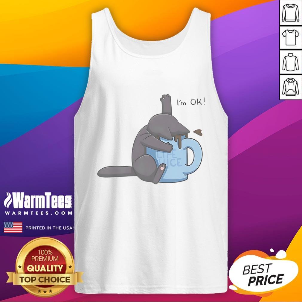 Cute cat playfully submerged in a coffee cup, wearing an I'm OK tank top, showcasing quirky pet humor.