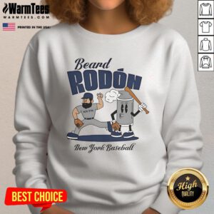 Carlos Rodon in a New York Yankees sweatshirt, showcasing his signature beard during mid-summer baseball.