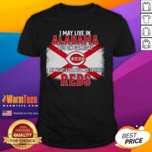 Good I May Live In Alabama But On Gameday My Heart And Soul Belongs To Reds T-Shirt displayed on a hanger.