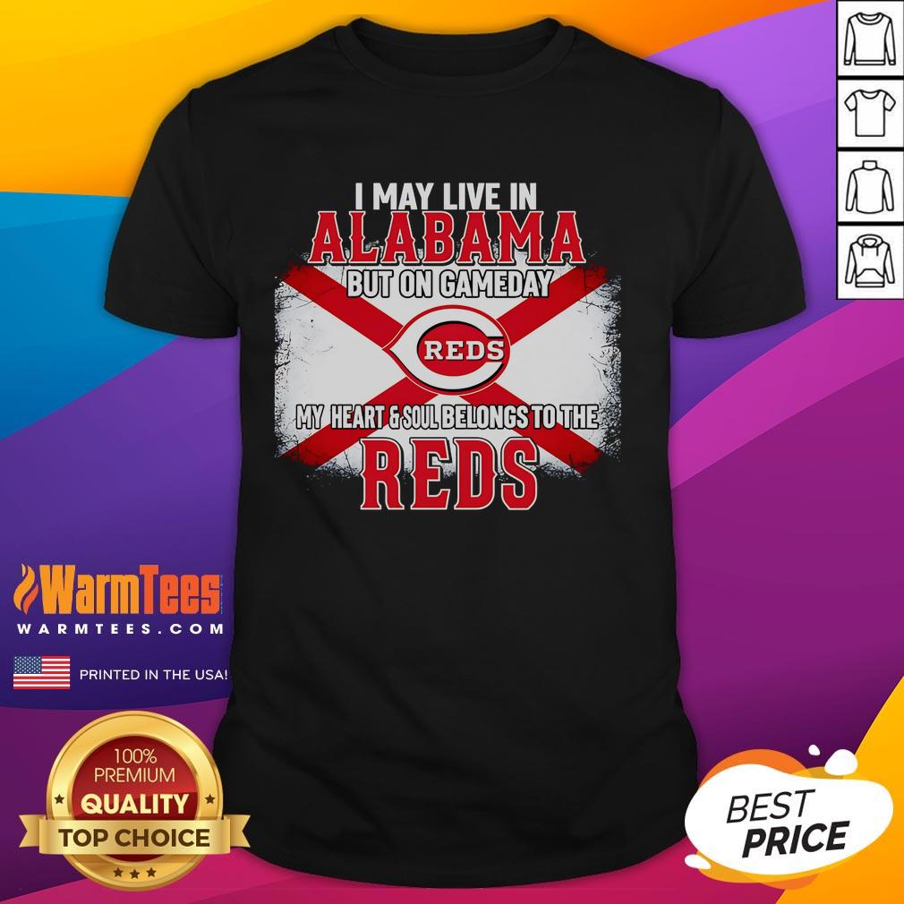 Good I May Live In Alabama But On Gameday My Heart And Soul Belongs To Reds T-Shirt displayed on a hanger.