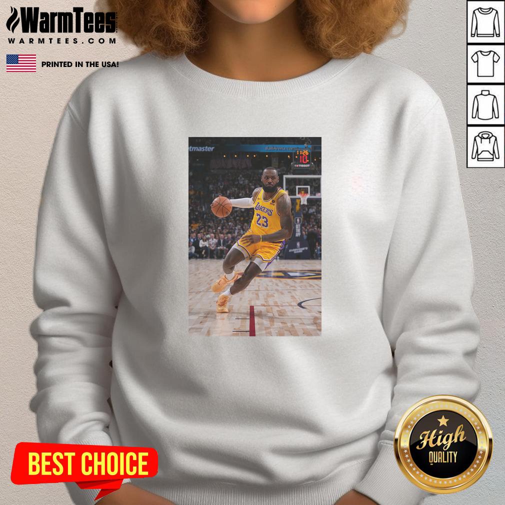 LeBron James in a stylish Los Angeles Lakers sweatshirt, showcasing his iconic Number 23 pose on the court.