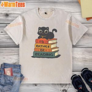 Alt Text: Cute cat lounging on a 'I Would Rather Be Reading' washed t-shirt, showcasing a cozy reading vibe.