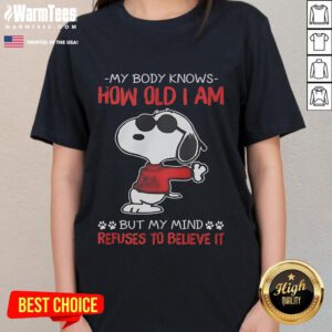 Funny Snoopy tee featuring 'My body knows how old I am, but my mind refuses' - perfect for humor-loving ladies.