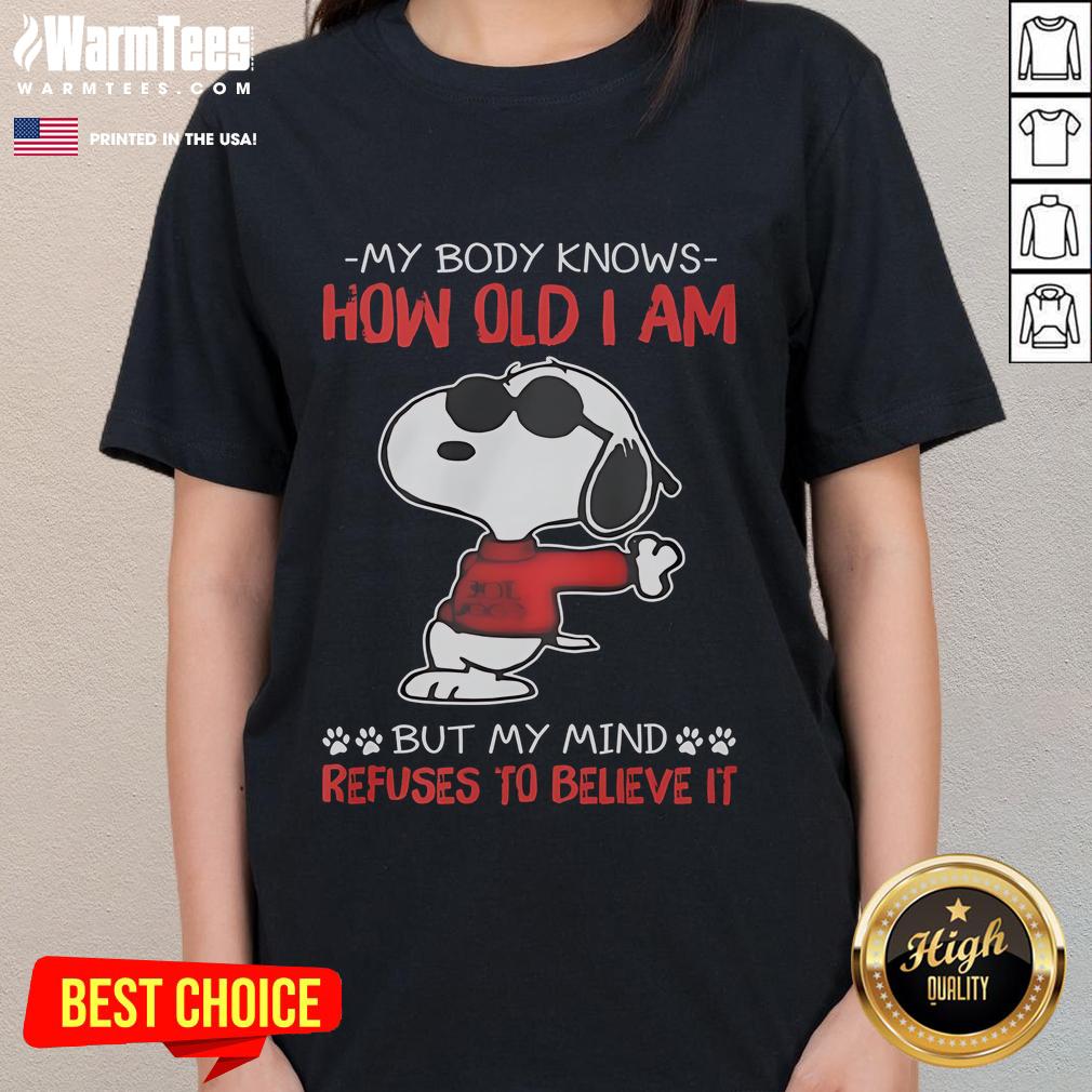Funny Snoopy tee featuring 'My body knows how old I am, but my mind refuses' - perfect for humor-loving ladies.