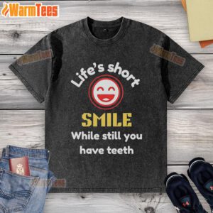Nice Life's Short Smile While Still You Have Teeth washed t-shirt displayed on a hanger against a vibrant background.