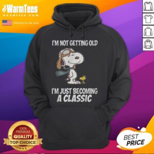 Alt Text: Snoopy hoodie with 'I'm not getting old, I'm just becoming a classic' text, perfect for nostalgic fans.