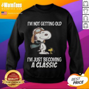 Snoopy sweatshirt with 'I'm not getting old, I'm just becoming a classic' slogan, perfect for fans of vintage style.