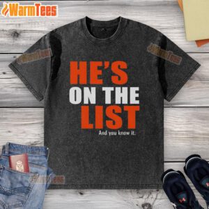 Official 'He's On The List And You Know It' washed t-shirt displayed on a wooden background, perfect for casual wear.