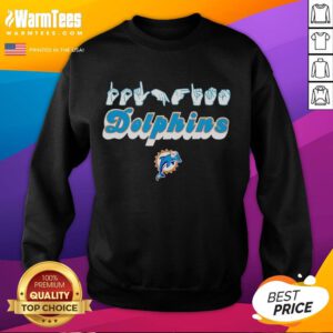 Youth in Miami Dolphins sweatshirt making love sign with hand signals, showcasing team spirit and style.